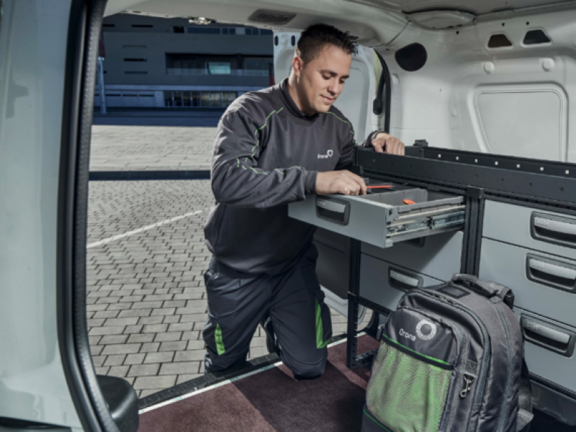 Orona worker inside a van